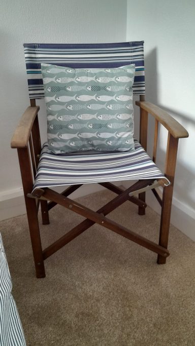 Blue and white chair with wooden legs