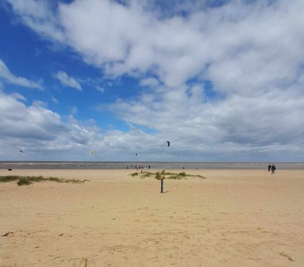 Sandy beach with blue sky and clouds