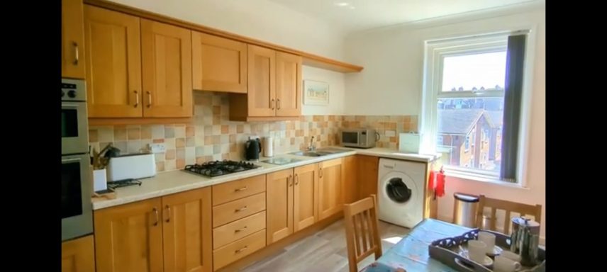 A kitchen with light brown wooden cupboards